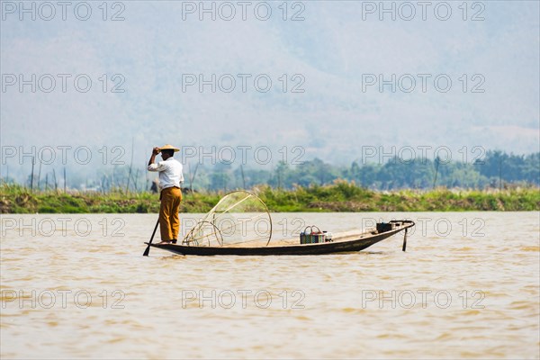 Local fisherman on wooden boat