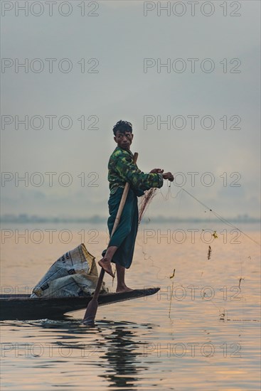Local fishermea leg rower with wooden boat