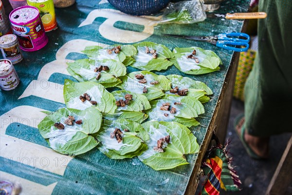 Market stall showing preparation of traditional chewing tobacco and betel nut