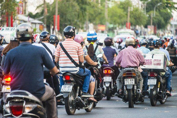 Crowd of scooter drivers in heavy traffic