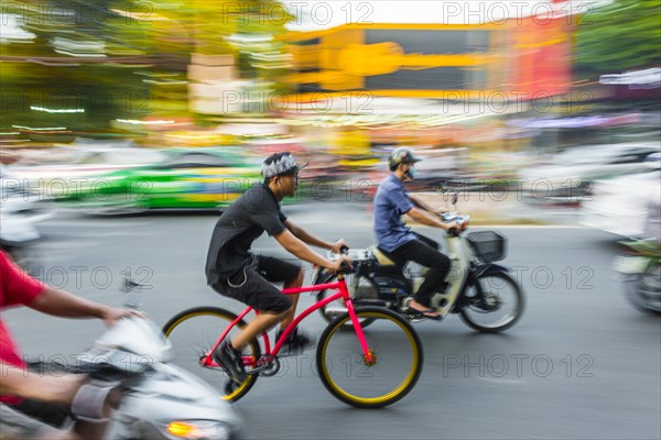 Cyclists and scooters in heavy traffic