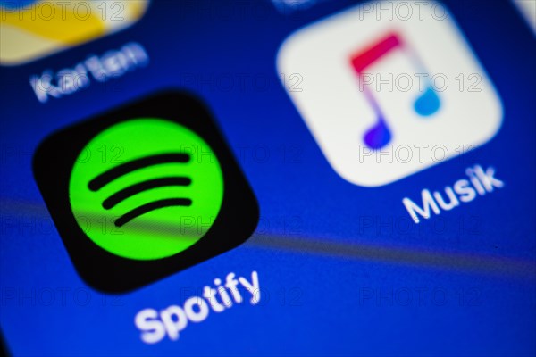 Smartphone screen with Music and Spotify app icons in detail