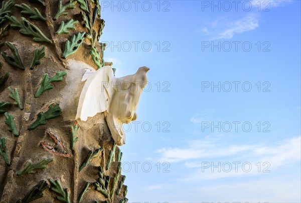 White dove of peace on the facade of the Sagrada Familia