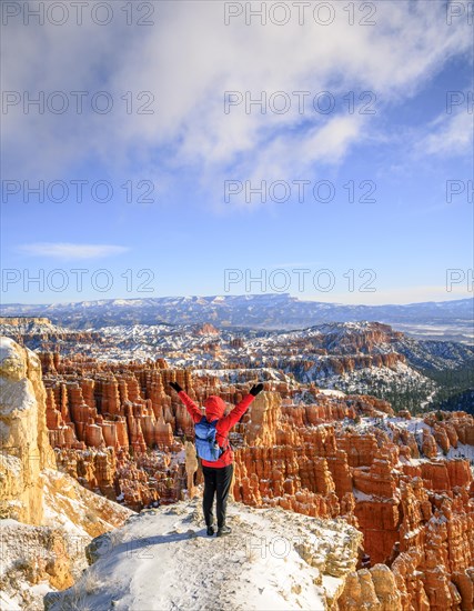 Young woman with outstretched arms overlooking the amphitheatre