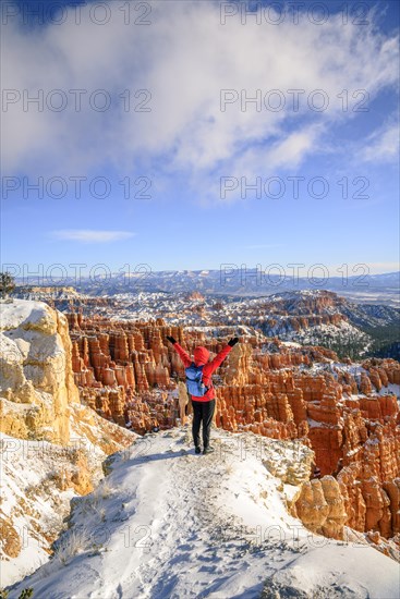 Young woman with outstretched arms and a view of the amphitheatre