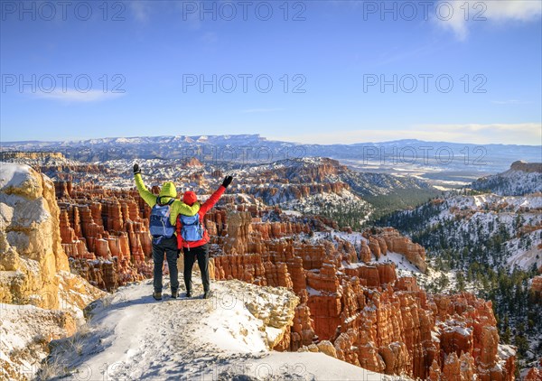 Tourists with outstretched arms overlooking the amphitheatre