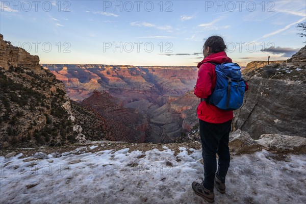 Young woman looking into the gorge of the Grand Canyon