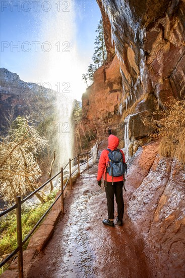 Hiker in front of waterfall