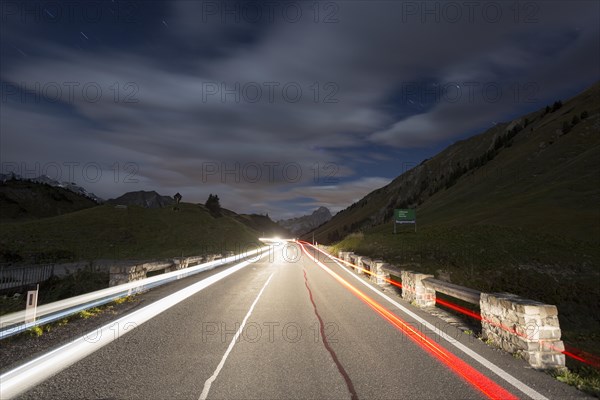 Pass road at night with light streaks from cars on Hochtannbergpass