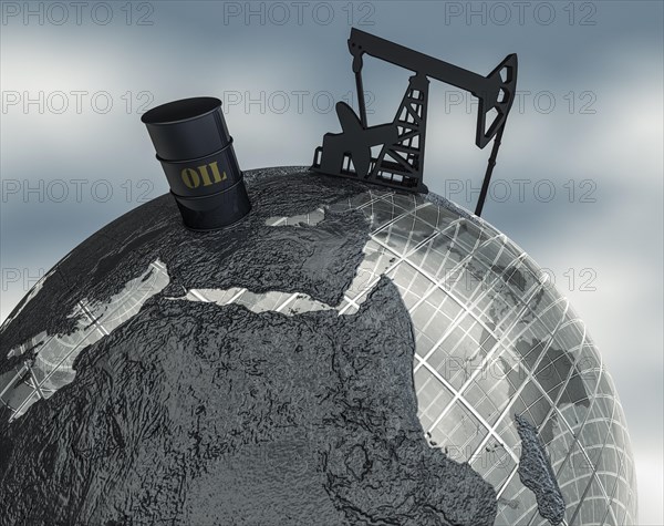 Globe with oil barrel and drilling rig