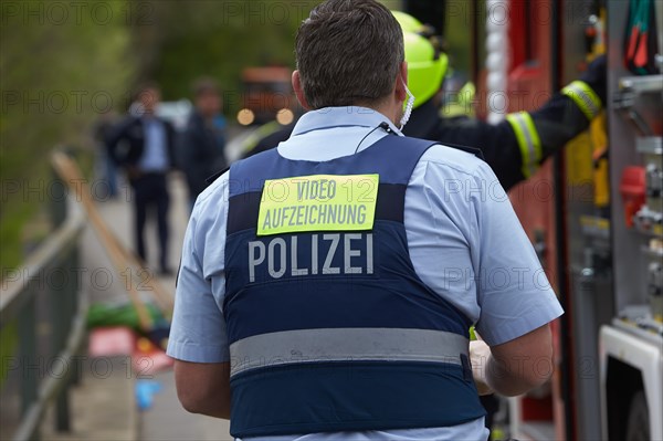 Police officer with sign on hois back