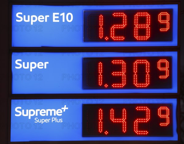 Illuminated Blue Electronic Price Board at a Petrol Station