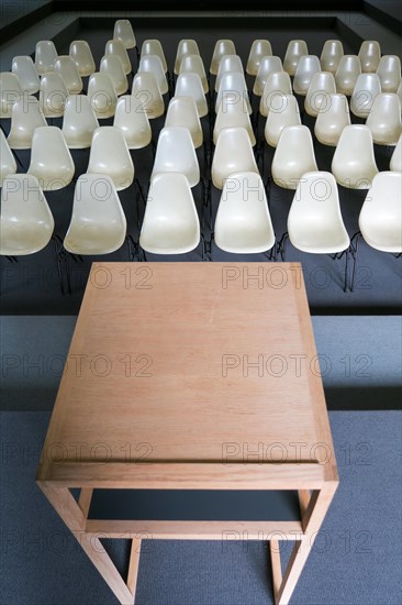 Empty chairs with desk in an auditorium