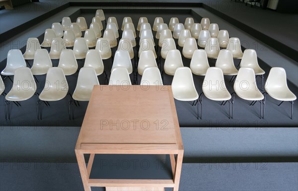 Empty chairs with desk in an auditorium