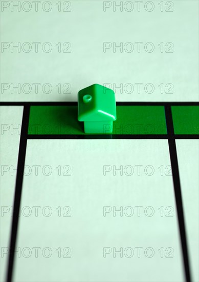 Green house in front of an empty playing field