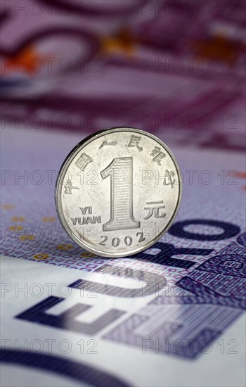 1 Yuan coin on euro banknote