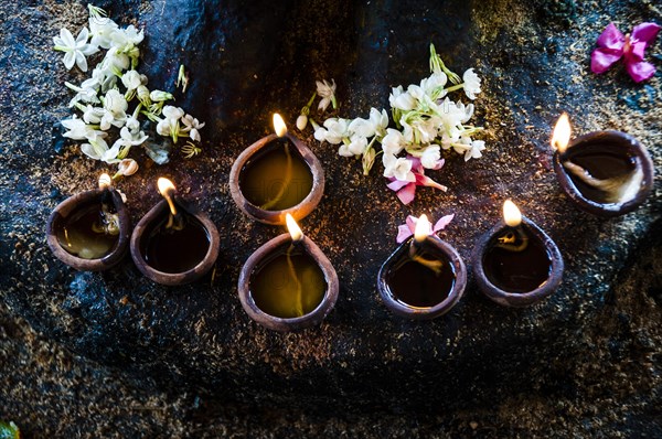 Offerings of flowers and oil burning lamps