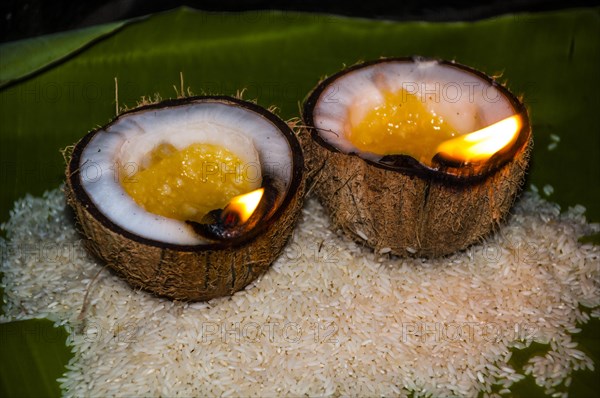 Offerings of rice and oil burning lamps in coconut shells