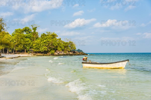 Idyllic beach with motor boat