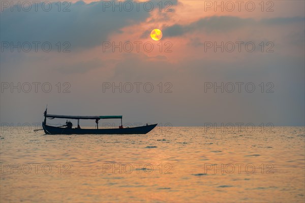 Boat on sea at sunrise from Koh Tui Beach