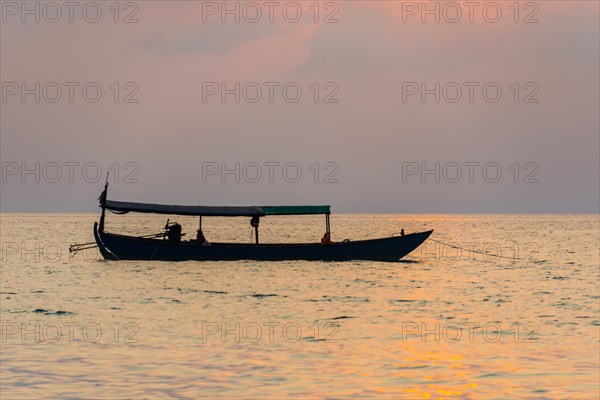 Boat on sea at sunrise from Koh Tui Beach