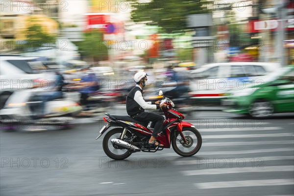 Scooter driver in heavy traffic