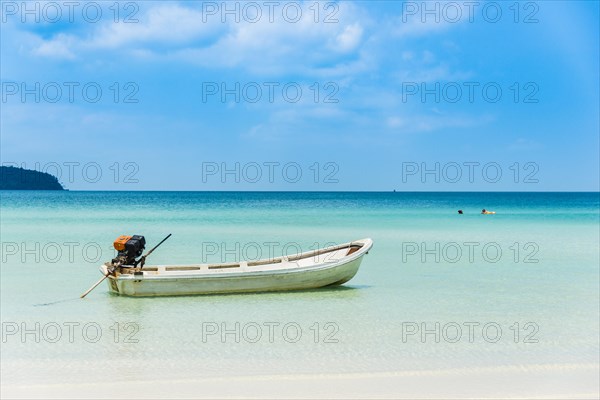 Motorboat on idyllic sandy beach