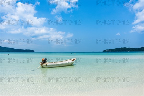 Motorboat on idyllic sandy beach