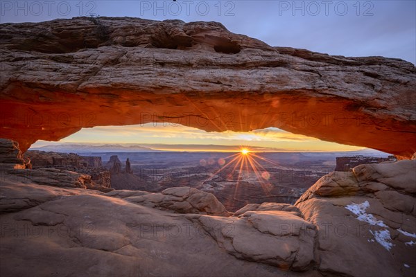 View through arch Mesa Arch at sunrise with sunstar