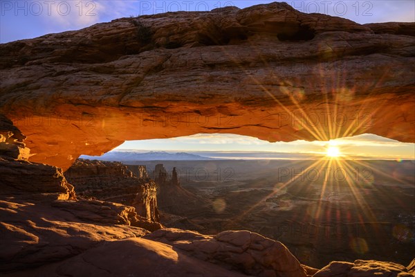 View through arch Mesa Arch at sunrise with sunstar