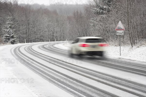 Car driving on snow-covered road