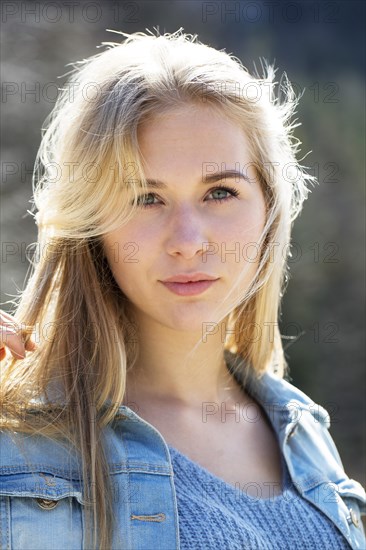 Portrait of a young woman with long blond hair