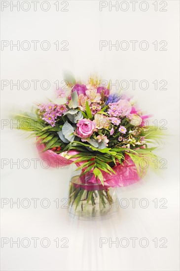 Bouquet in a glass vase against white background