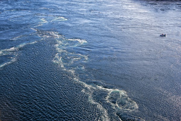 Small fishing boat near a dangerous whirlpool