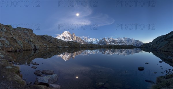 Moon and Mont Blanc reflected in the Lac des Chesery after sunset