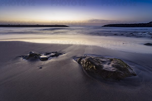 Beach with stones embedded in sand