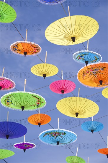 Colourful umbrellas suspended in the air at the umbrella festival in Bo Sang near Chiang Mai