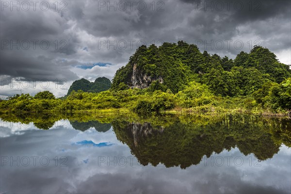 Karst hills with dark clouds