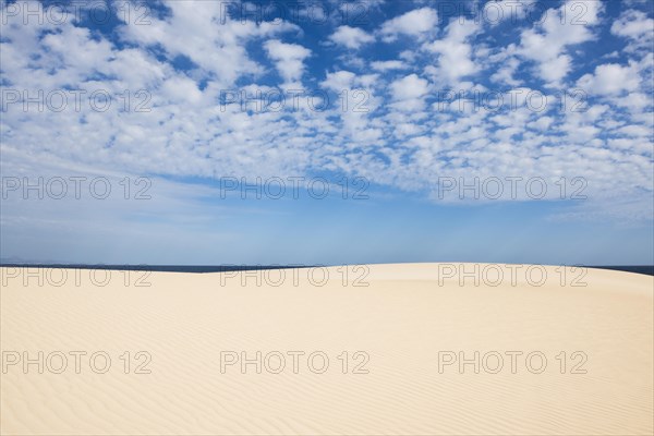 Dunes against blue sea