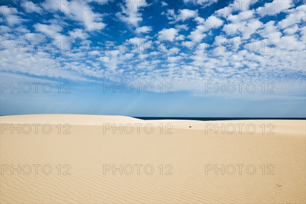 Dunes against blue sea