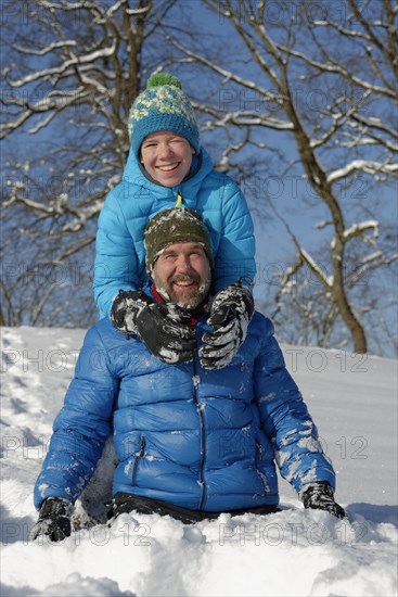 Father and son playing in the snow