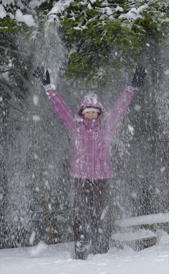Girl enjoying the snow in winter
