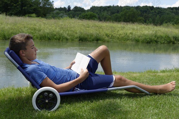 Boy lying in a deck chair