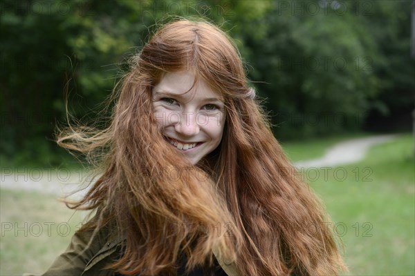 Teenage girl with long red hair