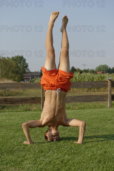 Teenage boy doing headstand