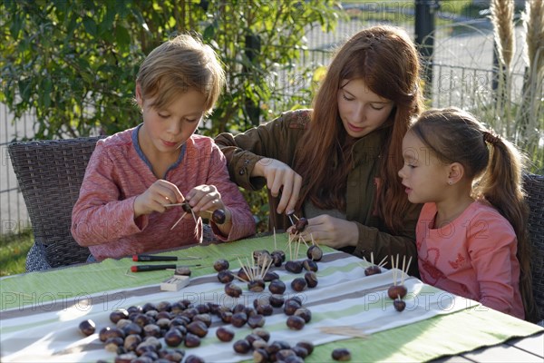 Children creating chestnut figures