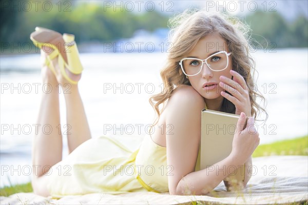 Pretty girl with glasses holding a book