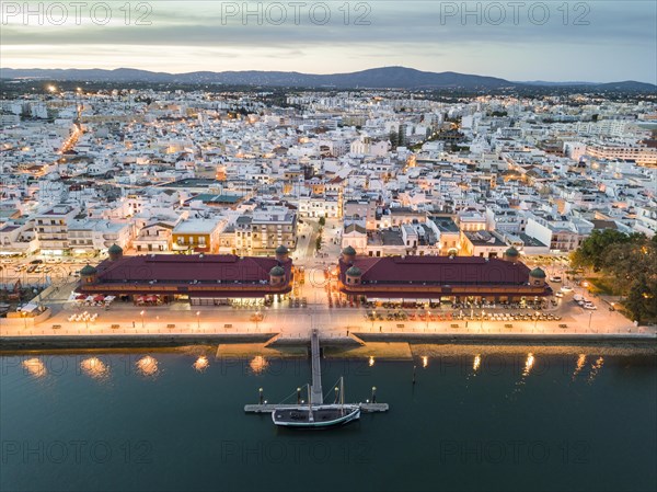 City view with two market buildings in the evening