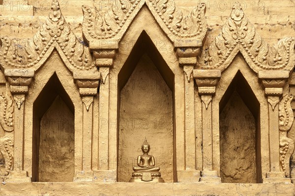 Small Buddha statue in a niche of the Wat Jong Kham