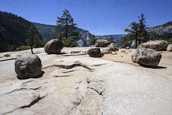 Round granite rocks on a granite surface